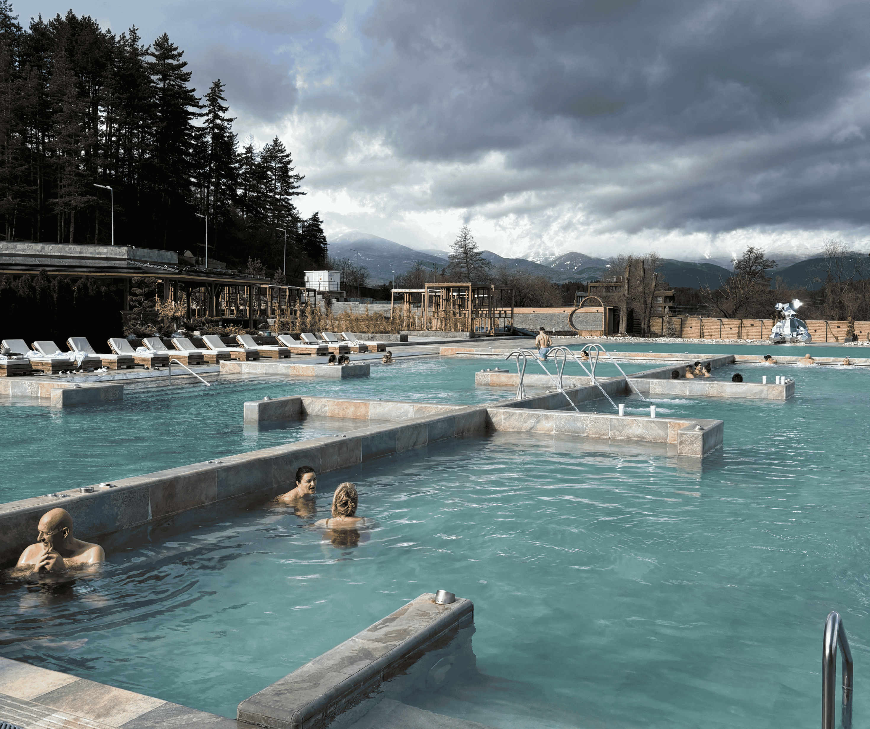 Outdoor thermal pools in Bulgaria with views of the Pirin mountains in winter